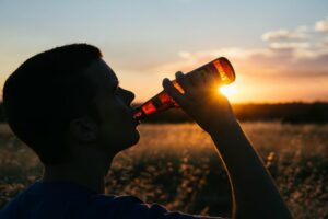 drinking bottle of beer sunset