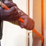 Burglar trying to break into a house with a crowbar