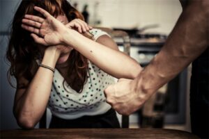 woman taking covering herself facing an abusive person